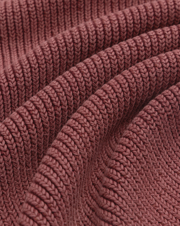 Close-up of textured, ribbed mauve fabric on the Stone Washed Knit Polo with soft, wavy folds.