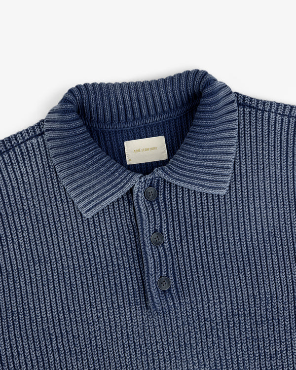 Stone Washed Knit Polo in blue, ribbed knit with a collar and three black buttons, shown chest up on white.
