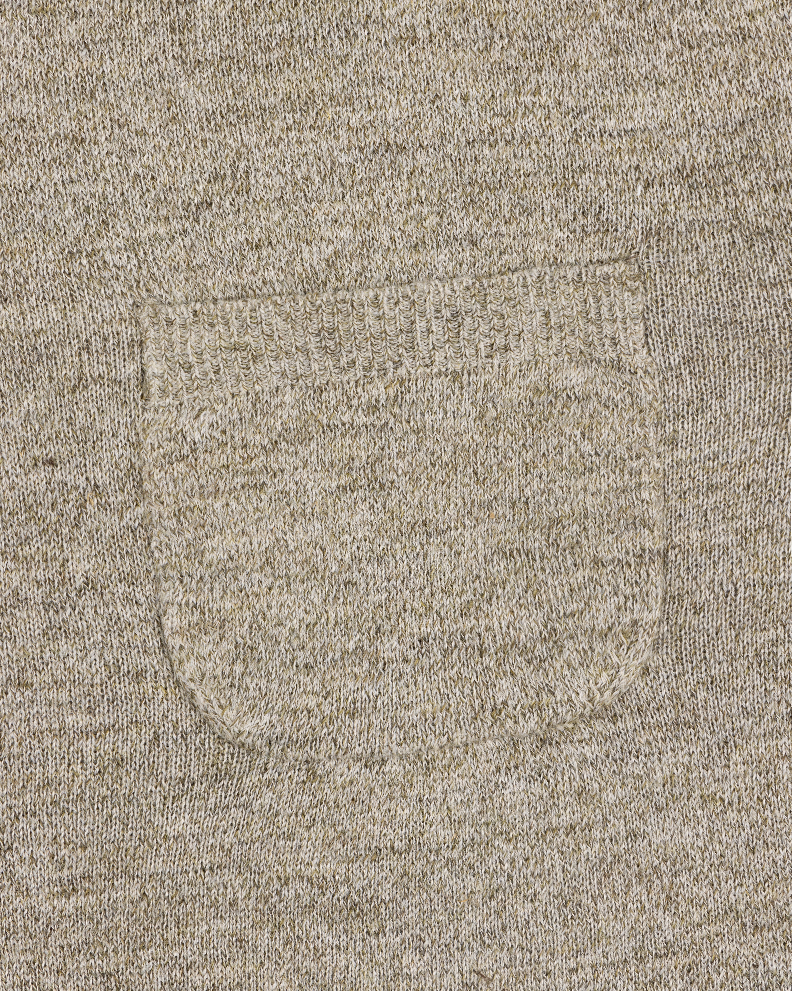 Close-up of a small sewn pocket on the Long-Sleeve Knit Pocket Tee, highlighting beige knit texture and stitching.