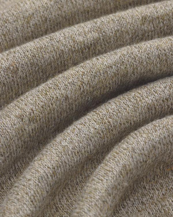 Close-up of folded beige Long-Sleeve Knit Pocket Tee showing soft texture and ribbed knit pattern.