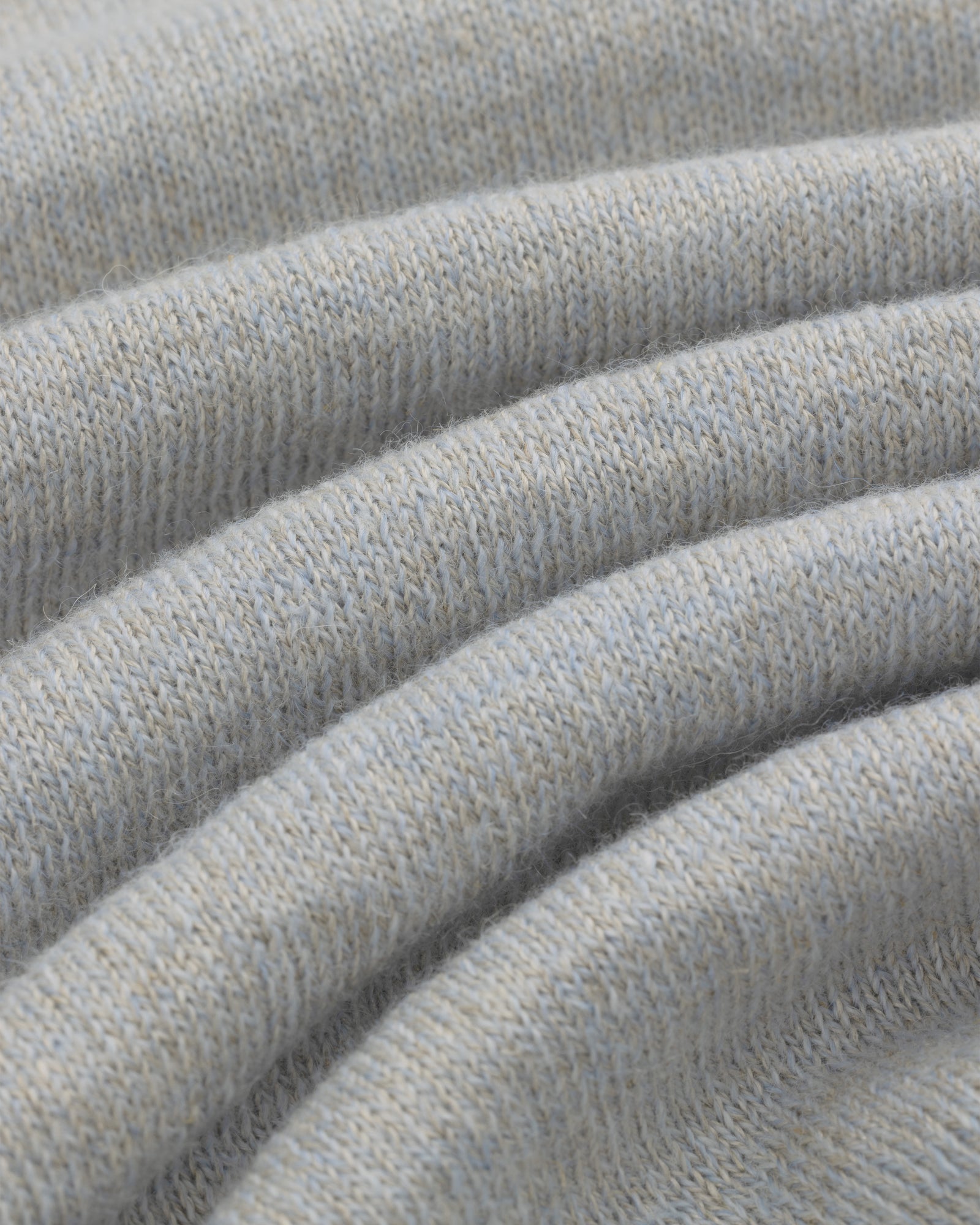 Close-up of soft, light gray Long-Sleeve Knit Pocket Tee fabric with visible texture and gentle folds.