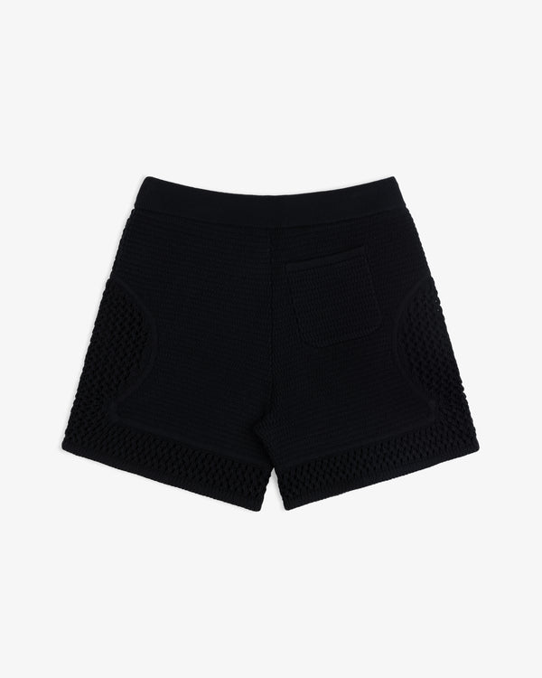 Knit Court Short in black textured knit with a single back pocket, shown on a plain white background.