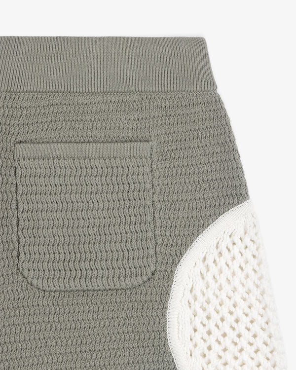 Close-up of the Knit Court Short's textured gray knit pocket with a contrasting white knit section on the side.