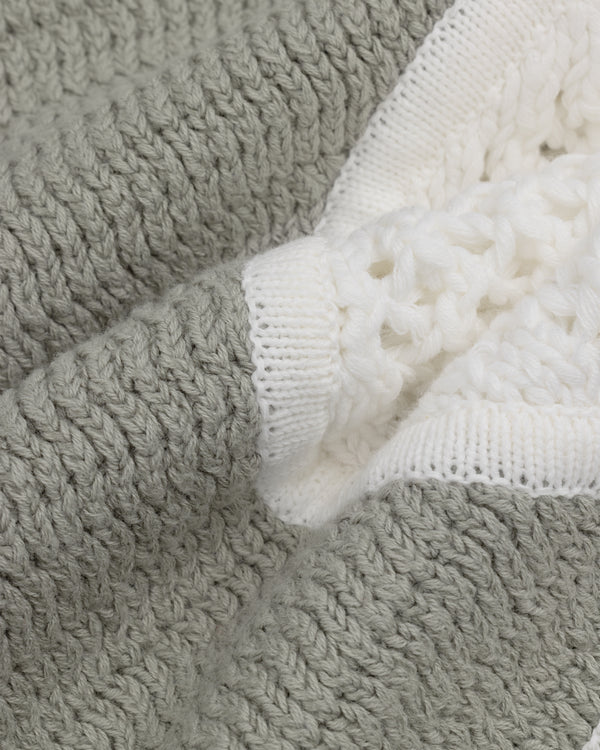 Close-up of Knit Court Short’s soft, gray and white chunky knit fabric with a textured pattern.