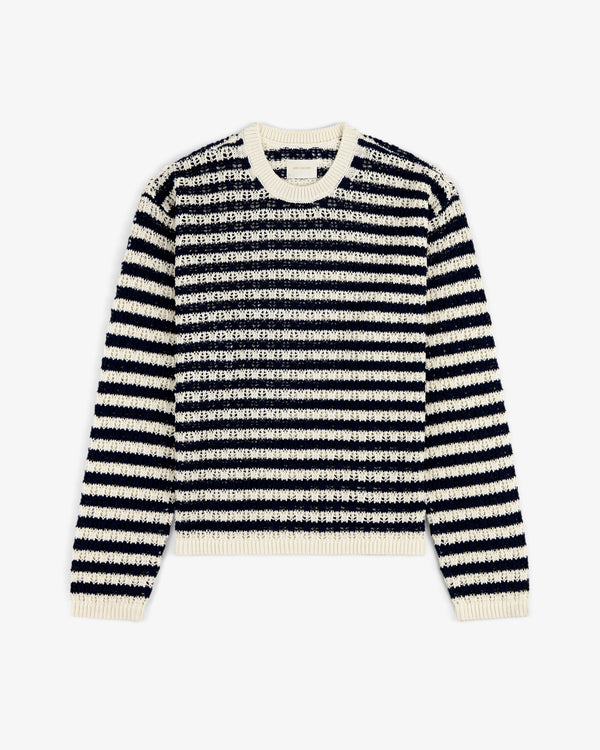 The Skáfos Sweater features long sleeves, black and white stripes, and a cream collar, cuffs, and hem.