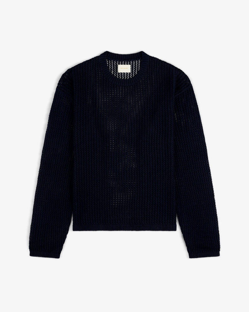 Cotton Eyelet Crewneck Sweater in navy blue with long sleeves, crochet-knit, laid flat on a white background.