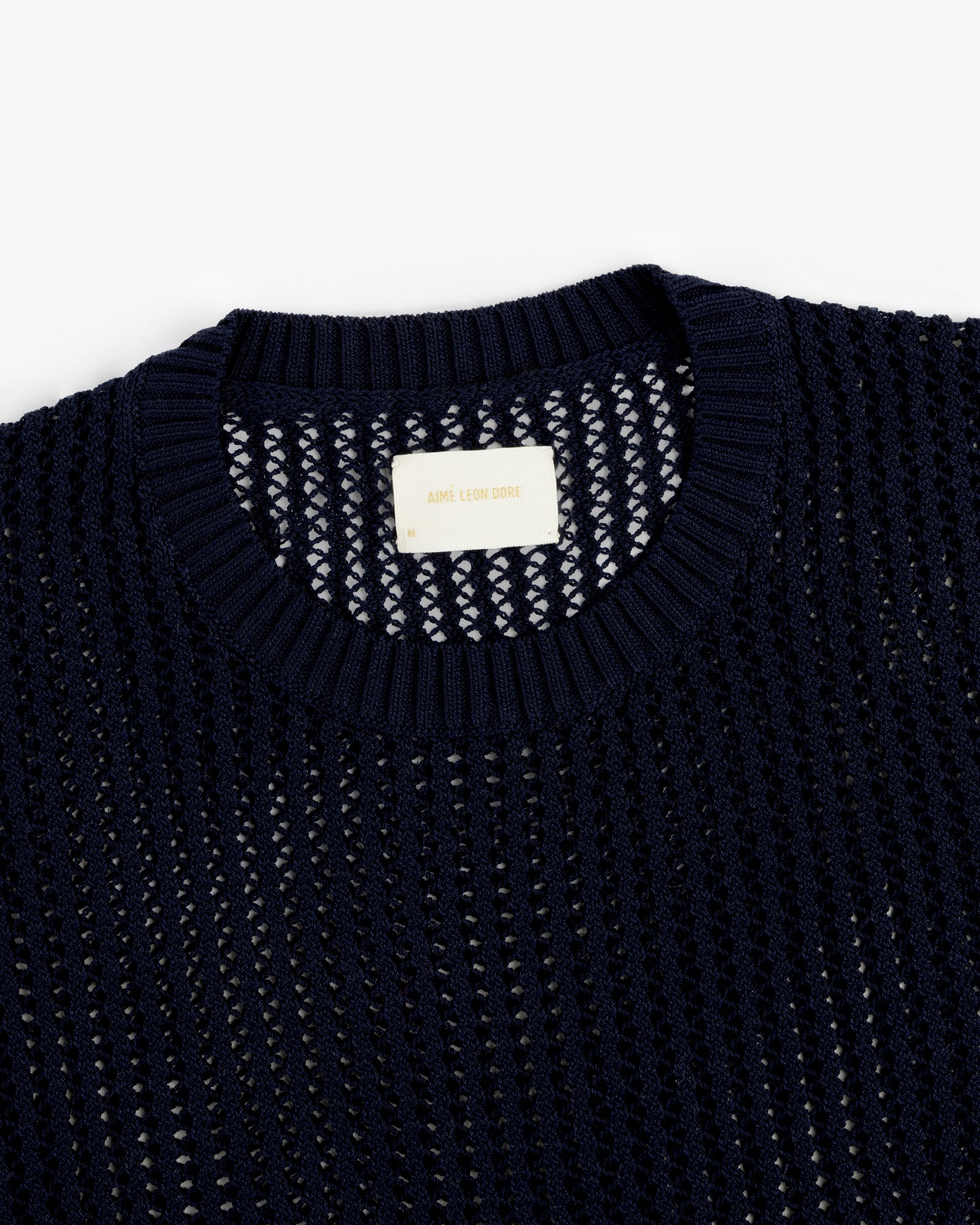 Navy blue Cotton Eyelet Crewneck Sweater with “Aimé Leon Dore” label on the inside collar.