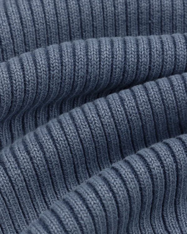 Close-up of Stone Washed Knit Tank Top in blue, showing ribbed fabric with wavy folds and detailed stitching.