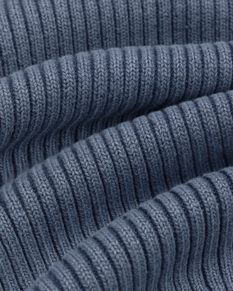 Close-up of Stone Washed Knit Tank Top in blue, showing ribbed fabric with wavy folds and detailed stitching.