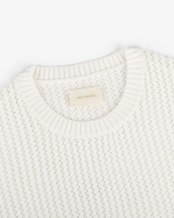 Fassianos "Rendez-Vous" Crewneck Sweater—white knit with open weave, ribbed neckline, and beige Aimé Leon Dore label.