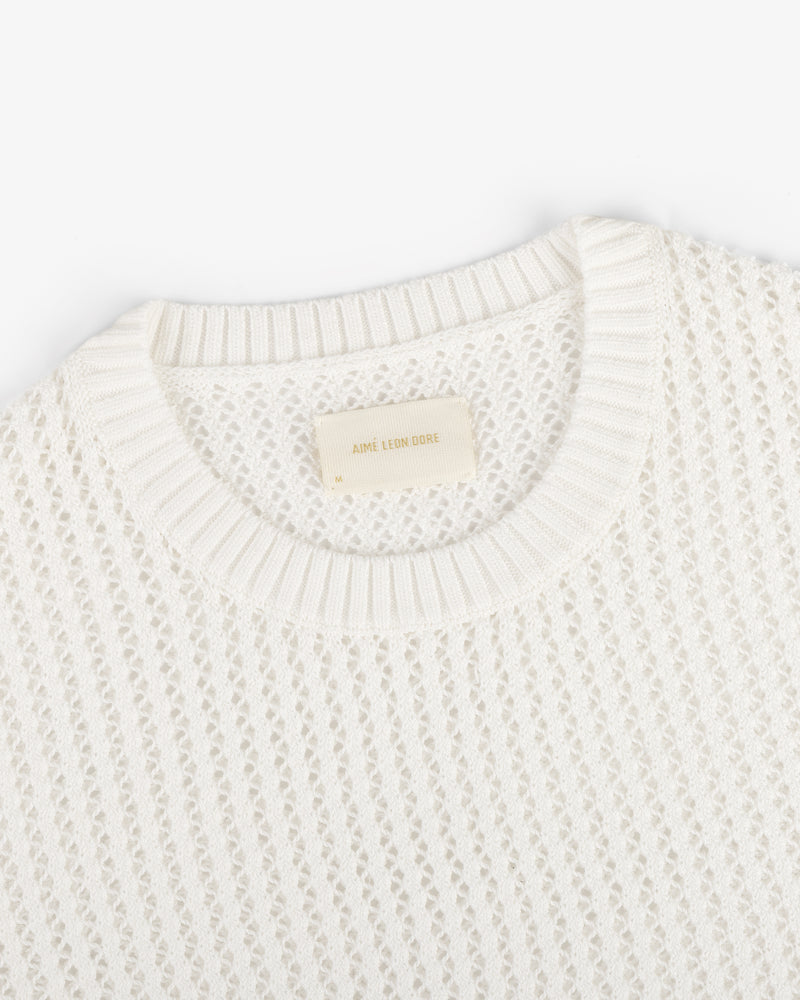 Fassianos "Rendez-Vous" Crewneck Sweater—white knit with open weave, ribbed neckline, and beige Aimé Leon Dore label.
