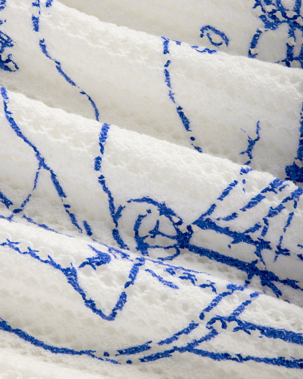 Close-up of Fassianos "Rendez - Vous" Crewneck Sweater's textured white fabric with abstract blue lines.