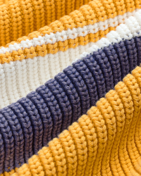 Close-up of Striped Knit Rugby fabric with yellow, white, and dark blue horizontal stripes.