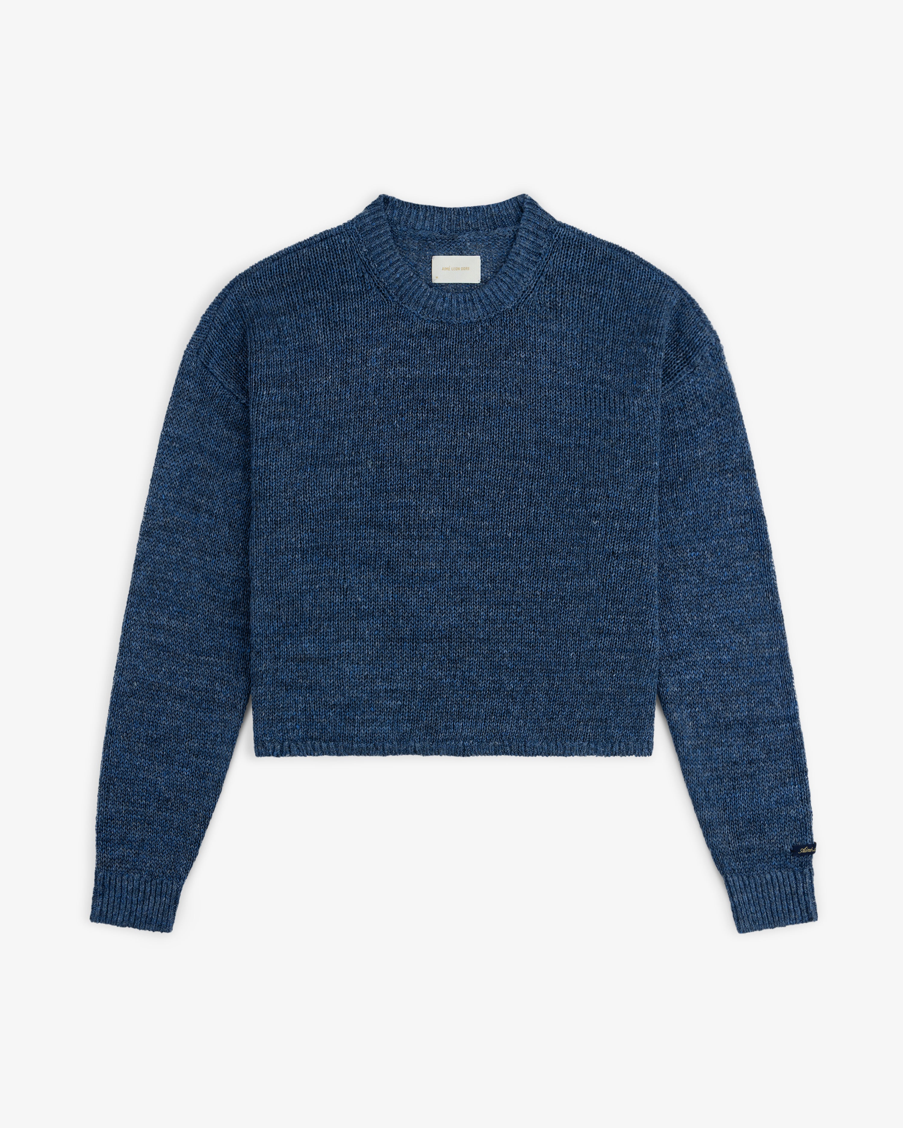 Linen Knit Crewneck Sweater with long sleeves, ribbed cuffs and hem, shown on a white background.