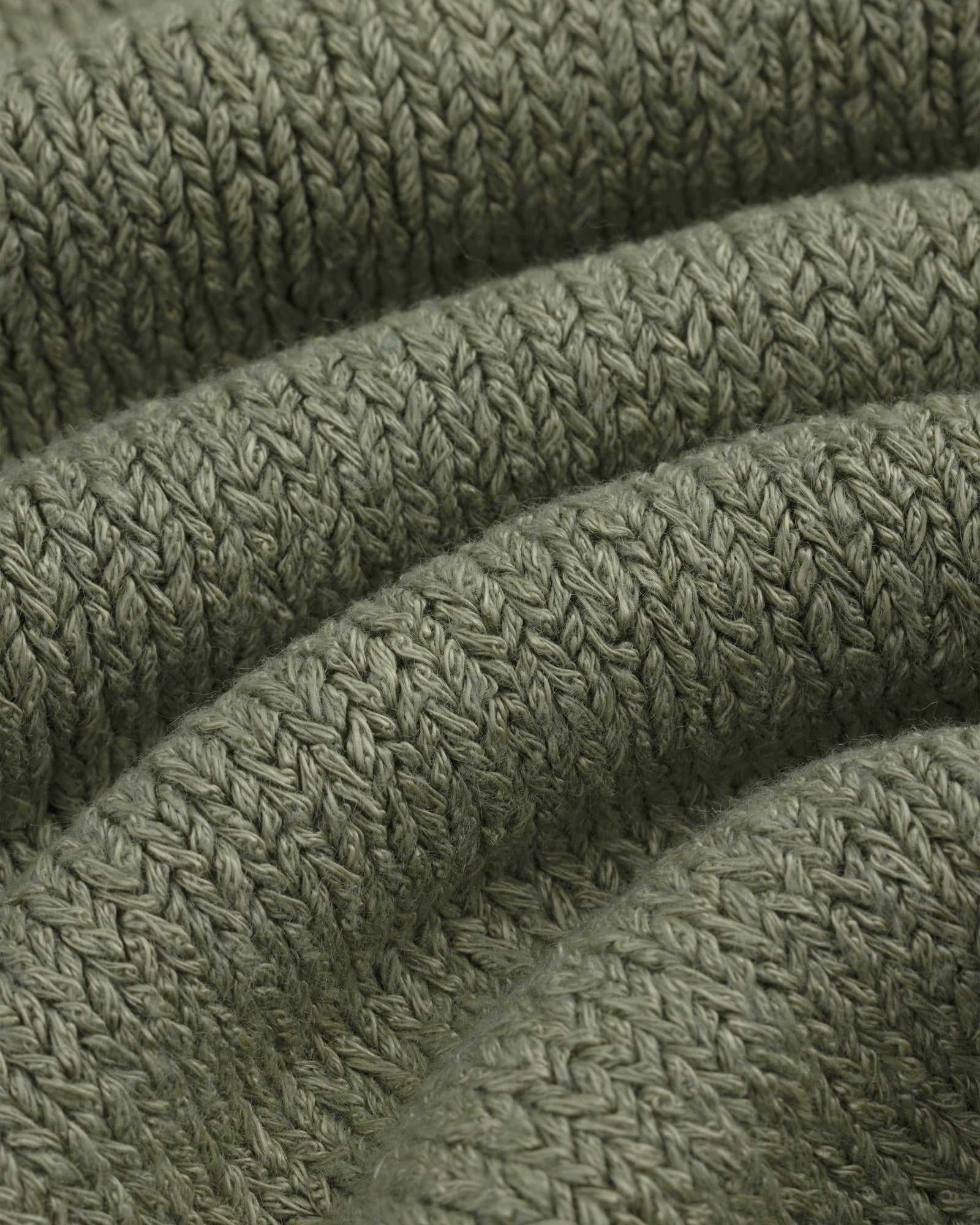 Close-up of Linen Knit Drawstring Short in olive green with visible textured stitches and curved folds.