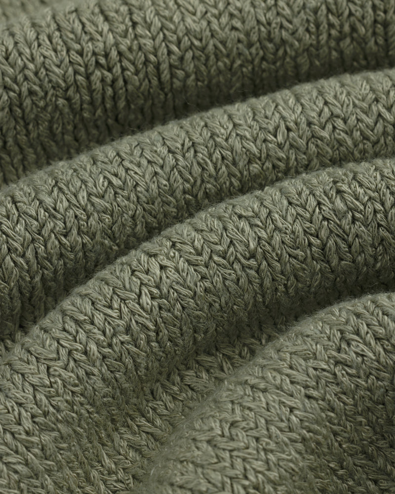Close-up of Linen Knit Drawstring Short in olive green with visible textured stitches and curved folds.