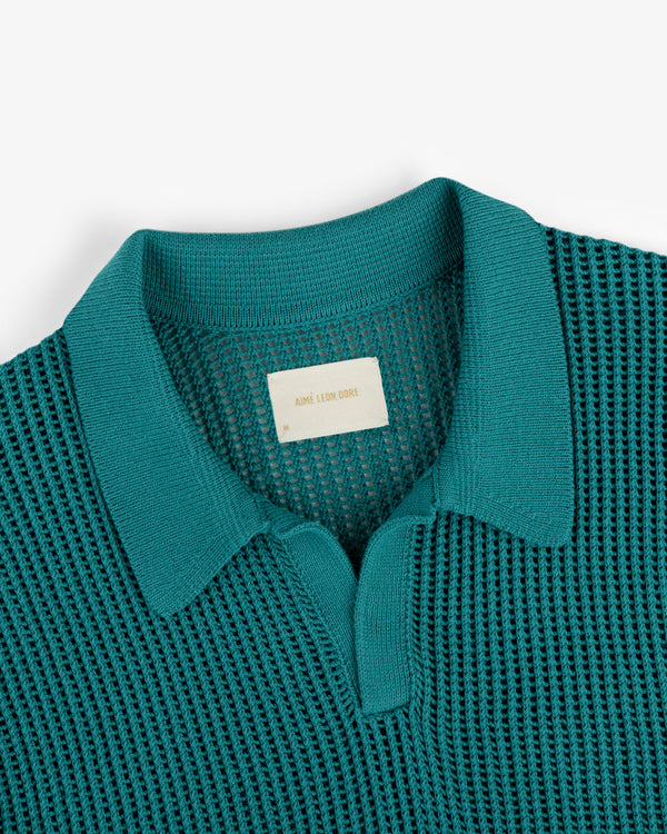 Teal Mesh Knit Polo with a textured pattern, partial button front, and visible beige label inside the collar.