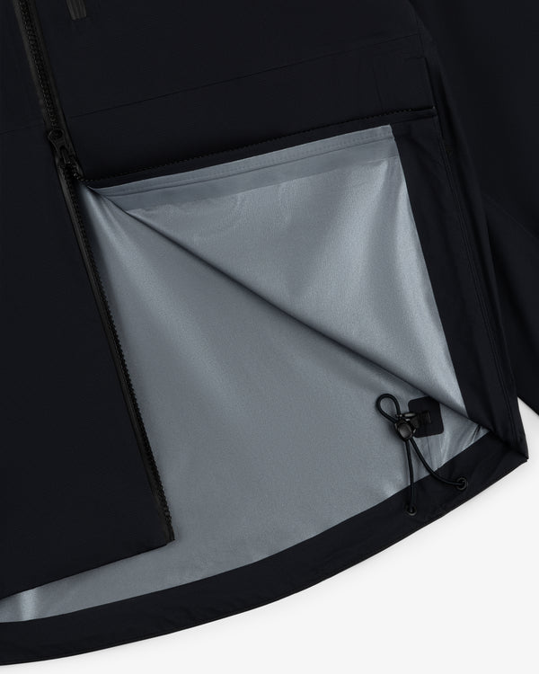 Close-up of the Lightweight GORE-TEX Shell Jacket with a partially open zipper, light gray lining, and drawstring.