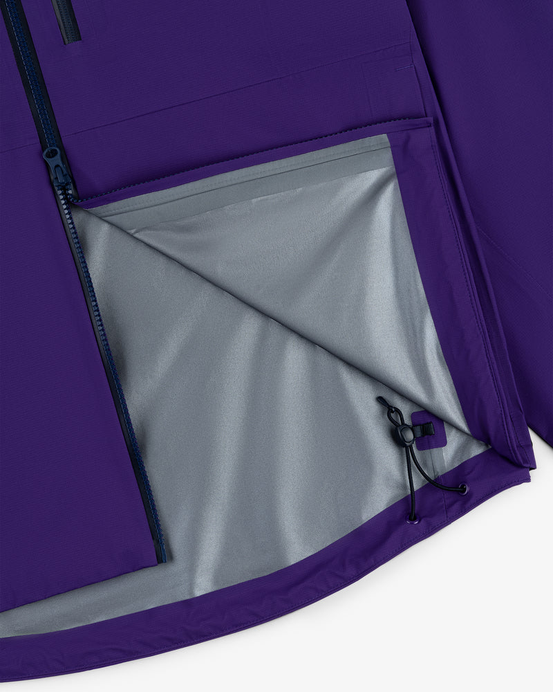 Close-up of the Lightweight GORE-TEX Shell Jacket’s purple interior pocket, grey lining, and adjustable drawstring hem.