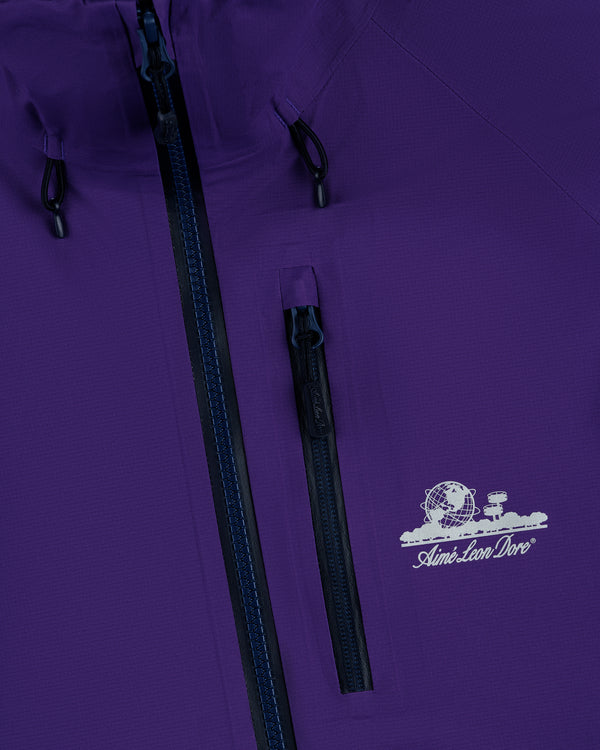 Close-up of the Lightweight GORE-TEX Shell Jacket in purple with black zippers and a white Aimé Leon Dore chest logo.