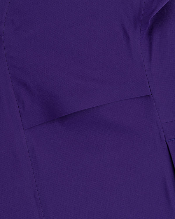 Close-up of a Lightweight GORE-TEX Shell Jacket in purple, featuring visible stitching and seam lines.