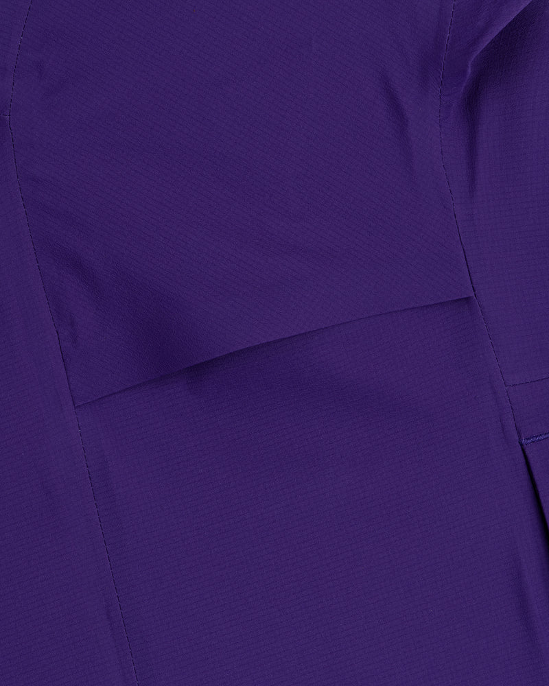 Close-up of a Lightweight GORE-TEX Shell Jacket in purple, featuring visible stitching and seam lines.