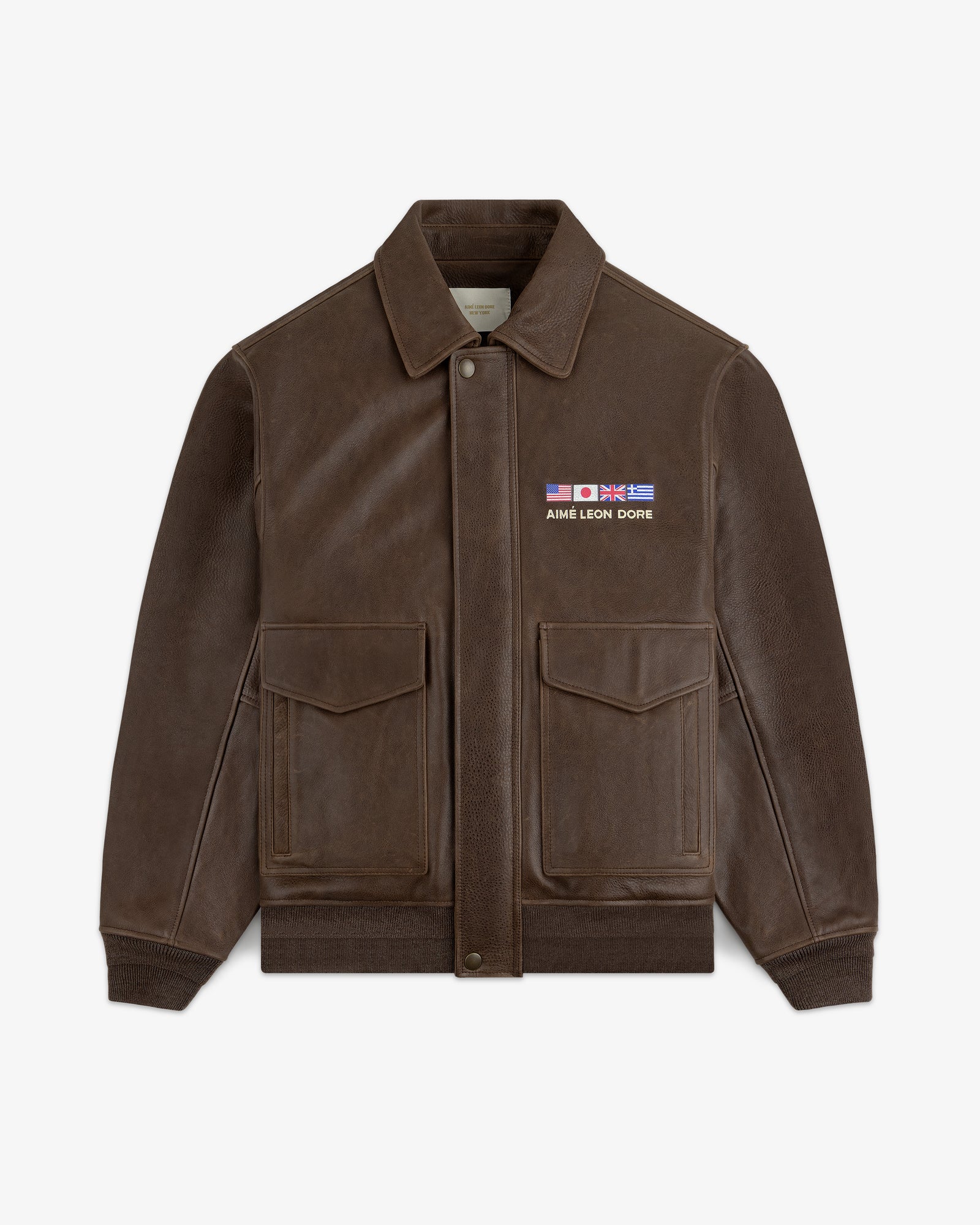 World's Borough Leather Flight Jacket: brown with two front pockets, collar, and AIME LEON DORE flag patches.
