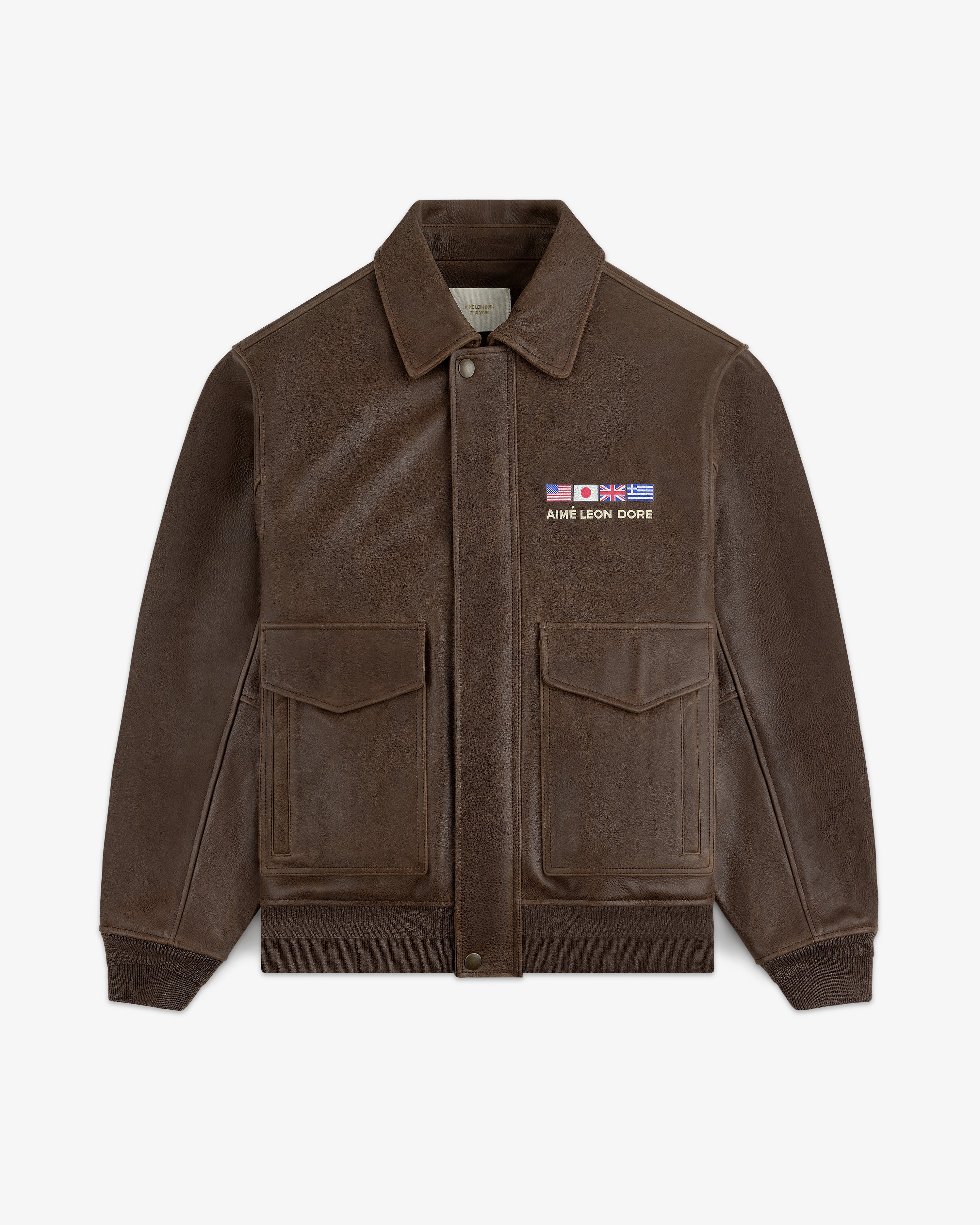 World's Borough Leather Flight Jacket: brown with two front pockets, collar, and AIME LEON DORE flag patches.
