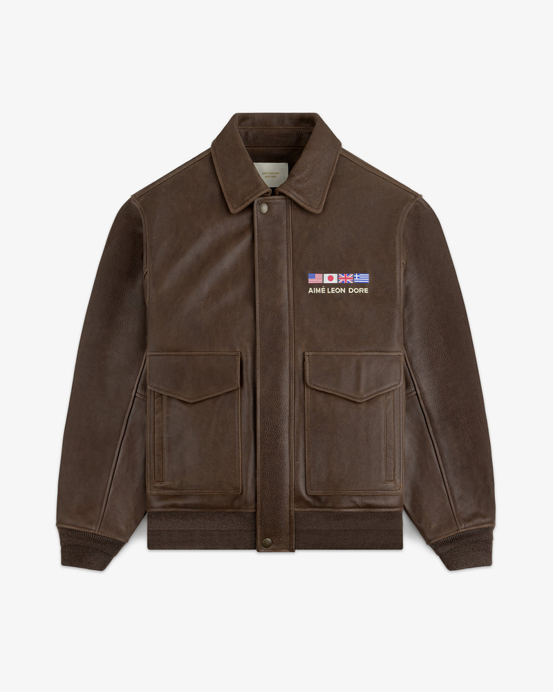 World's Borough Leather Flight Jacket: brown with two front pockets, collar, and AIME LEON DORE flag patches.