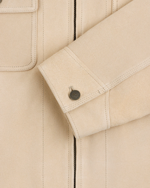 Close-up of a Leather Ranch Jacket in beige, showing a textured sleeve with buttoned cuff and visible stitching.