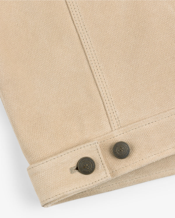 Close-up of the Leather Ranch Jacket's beige textured sleeve with two metallic buttons and stitched seams.