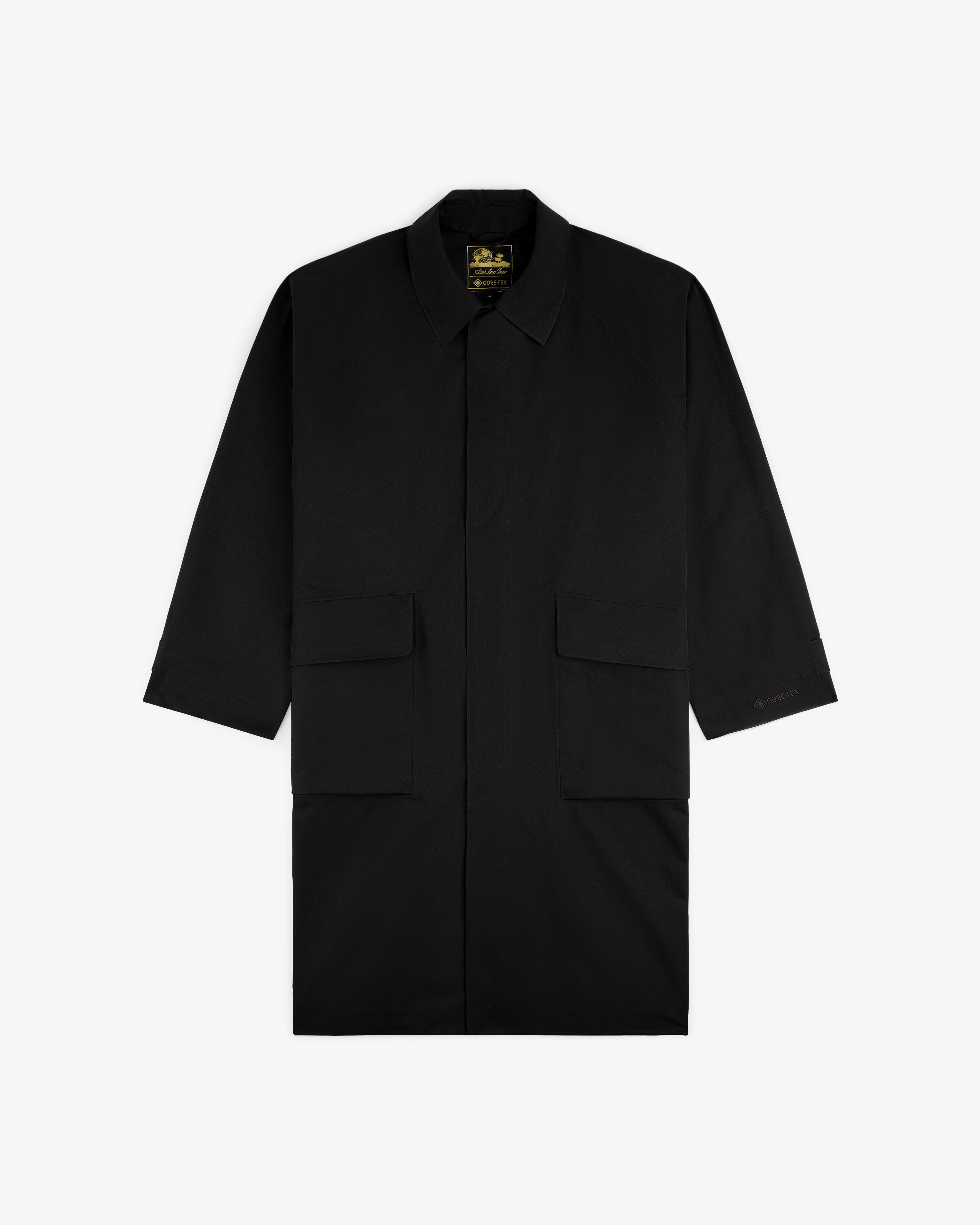 GORE-TEX Balmacaan Coat with a collar and two large front flap pockets, shown on a white background.