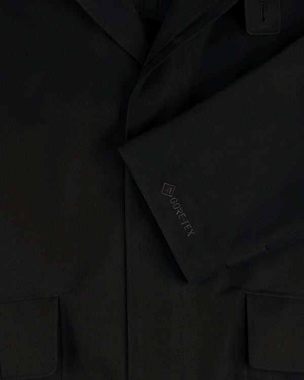 Close-up of the GORE-TEX Balmacaan Coat sleeve with embroidered logo and lower pockets visible.