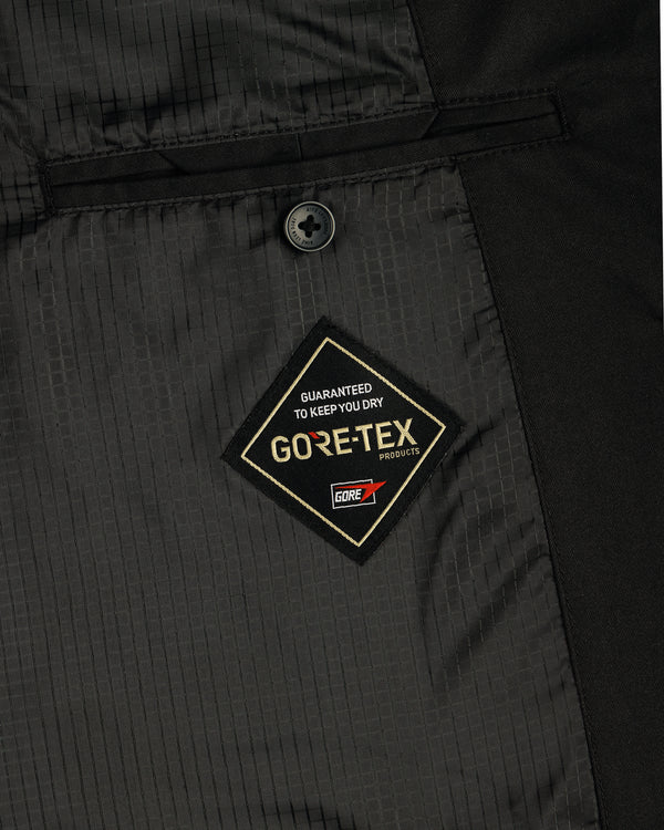 Close-up of the GORE-TEX Balmacaan Coat’s inside pocket featuring a GORE-TEX label and a single black button above it.