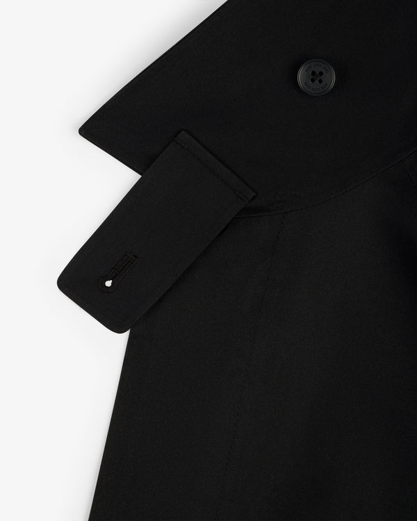 Close-up of GORE-TEX Balmacaan Coat shoulder with button, collar detail, and strap featuring a stitched buttonhole.