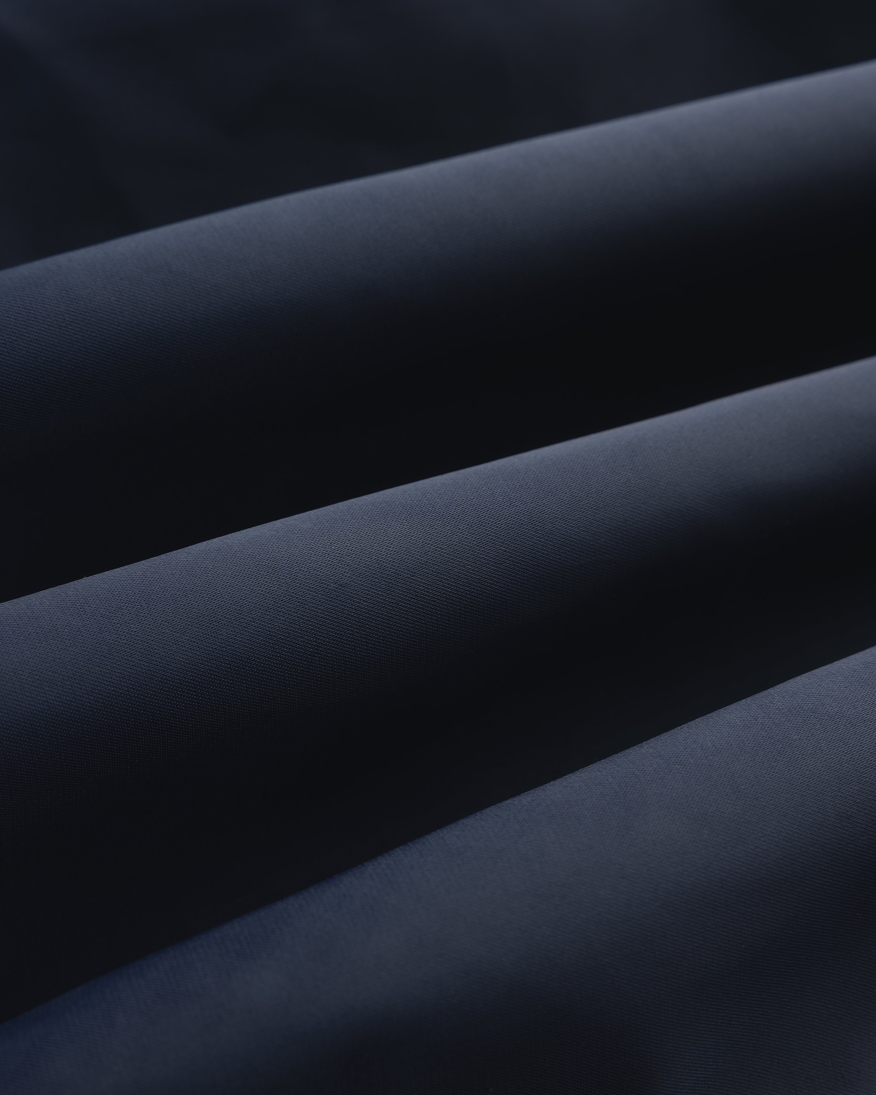 Close-up of Overlay Logo Satin Varsity Jacket in dark blue, highlighting its smooth texture and soft folds.