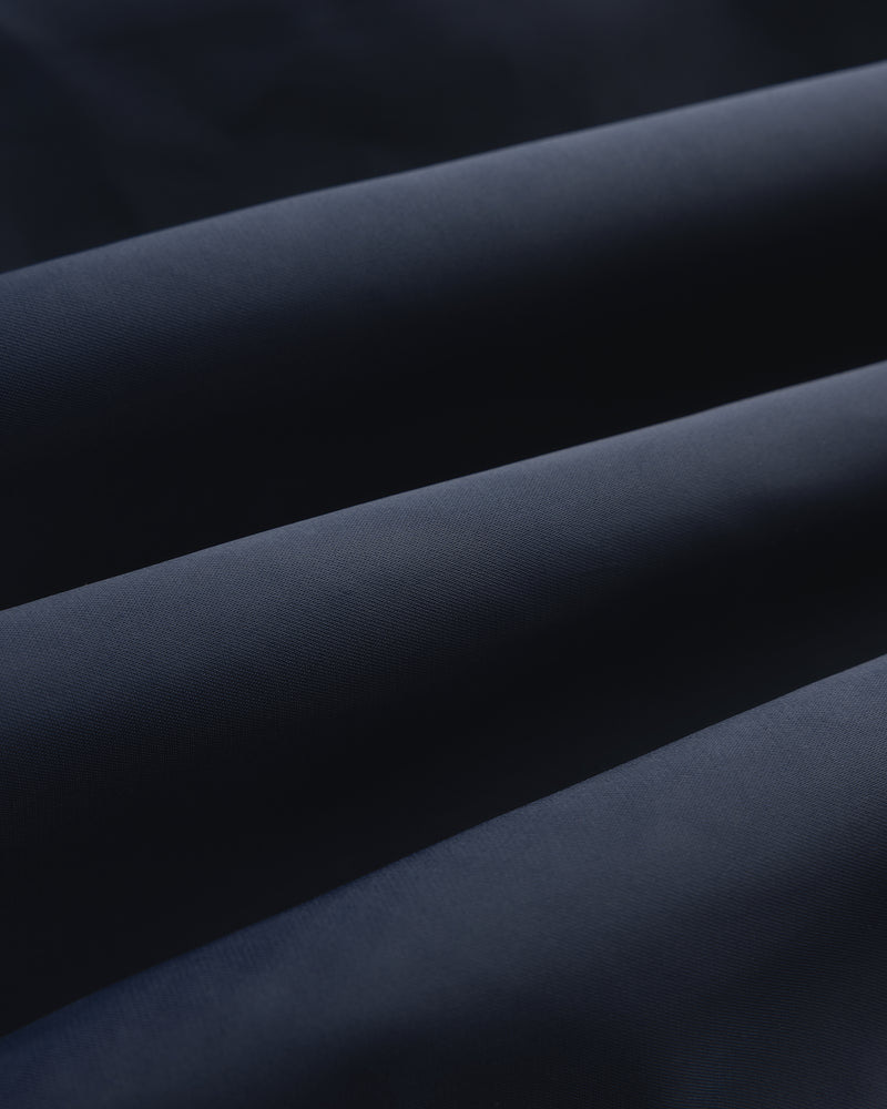 Close-up of Overlay Logo Satin Varsity Jacket in dark blue, highlighting its smooth texture and soft folds.