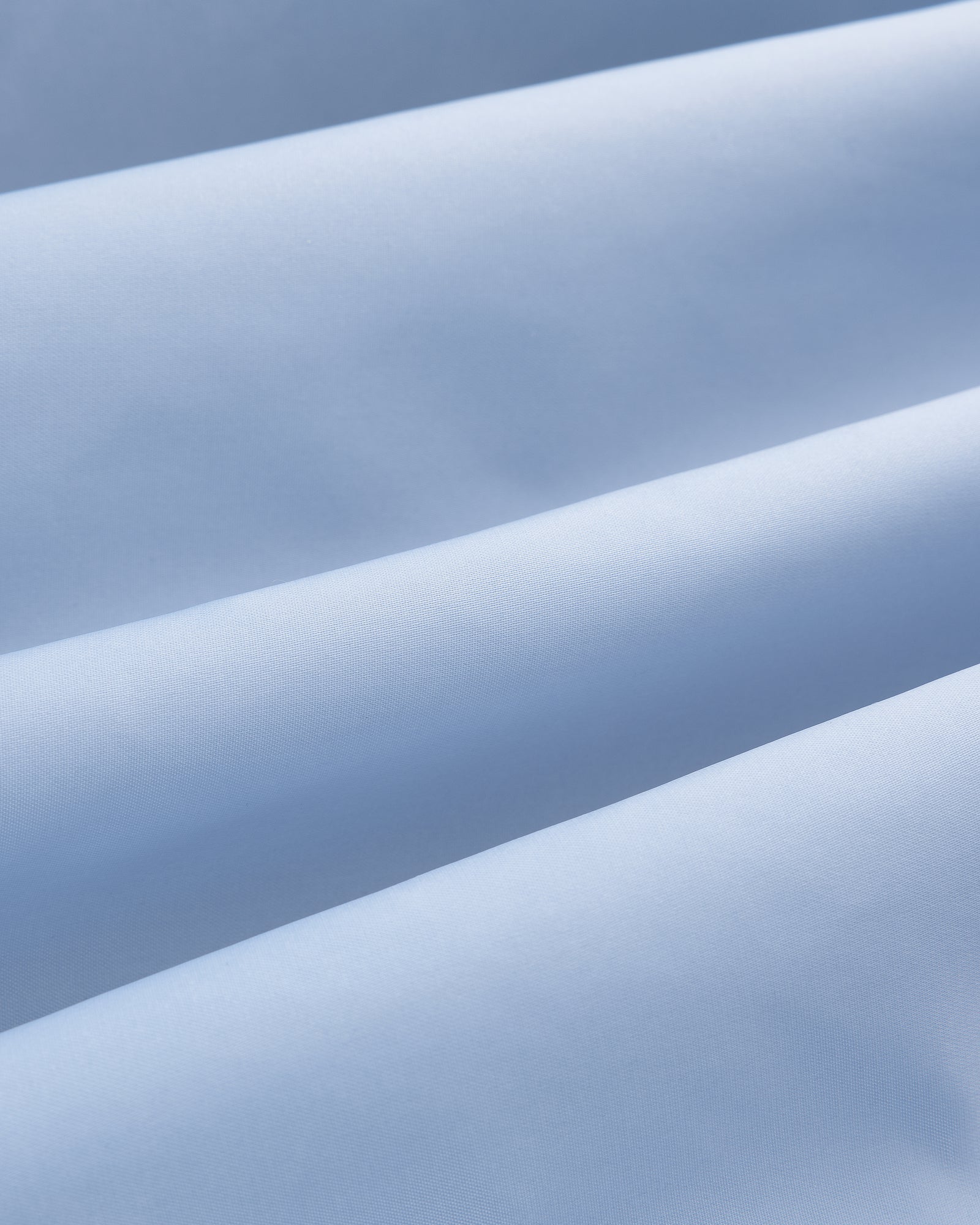 Close-up of Overlay Logo Satin Varsity Jacket in light blue, showing soft folds and smooth, gently ridged texture.