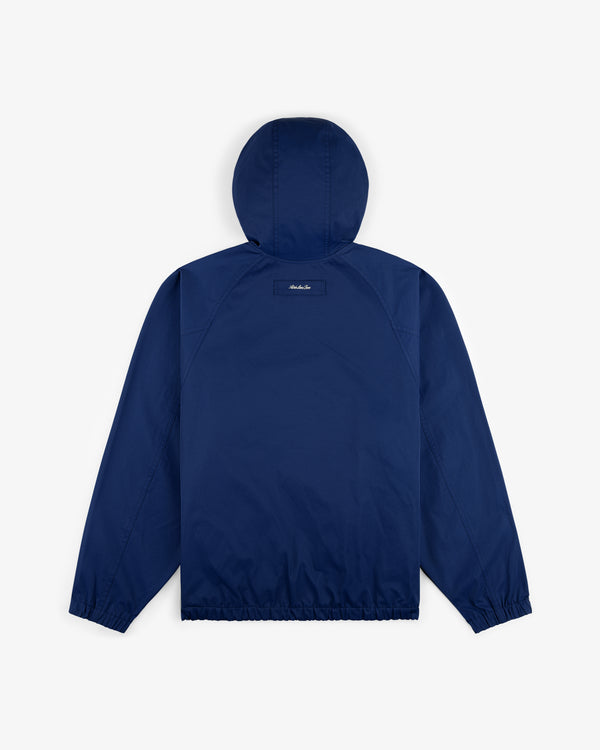 Reversible Madras Windbreaker in navy blue, shown from the back with elastic cuffs and hem on a white background.