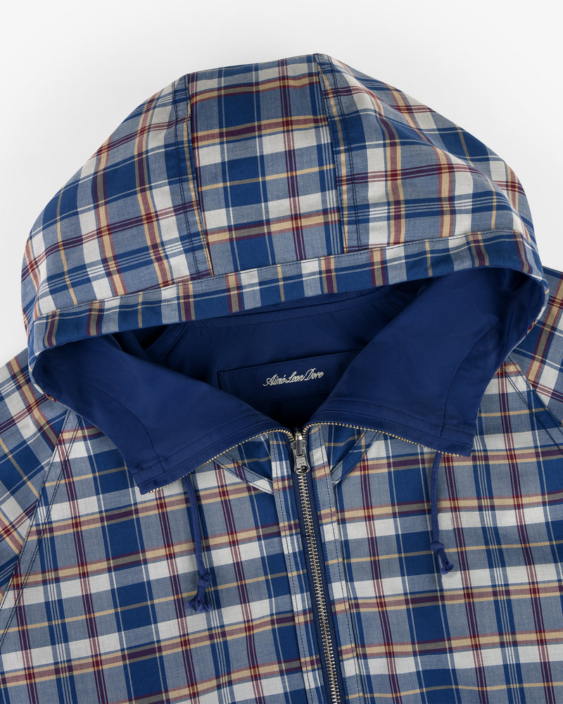 Reversible Madras Windbreaker in blue, white, and red plaid with hood, zipper, and solid blue lining, top view.