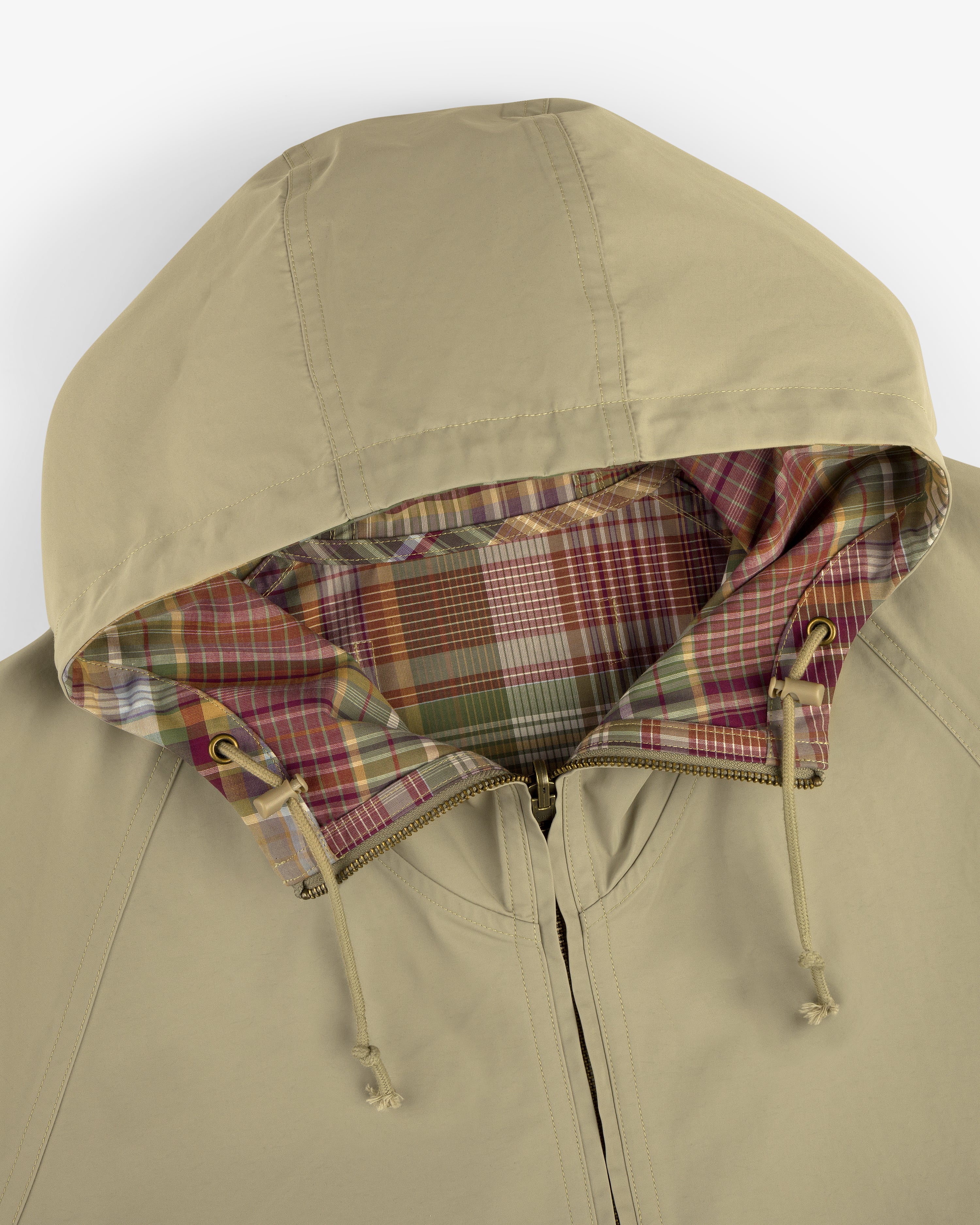 Beige Reversible Madras Windbreaker with multicolored plaid lining and drawstrings, shown from above.