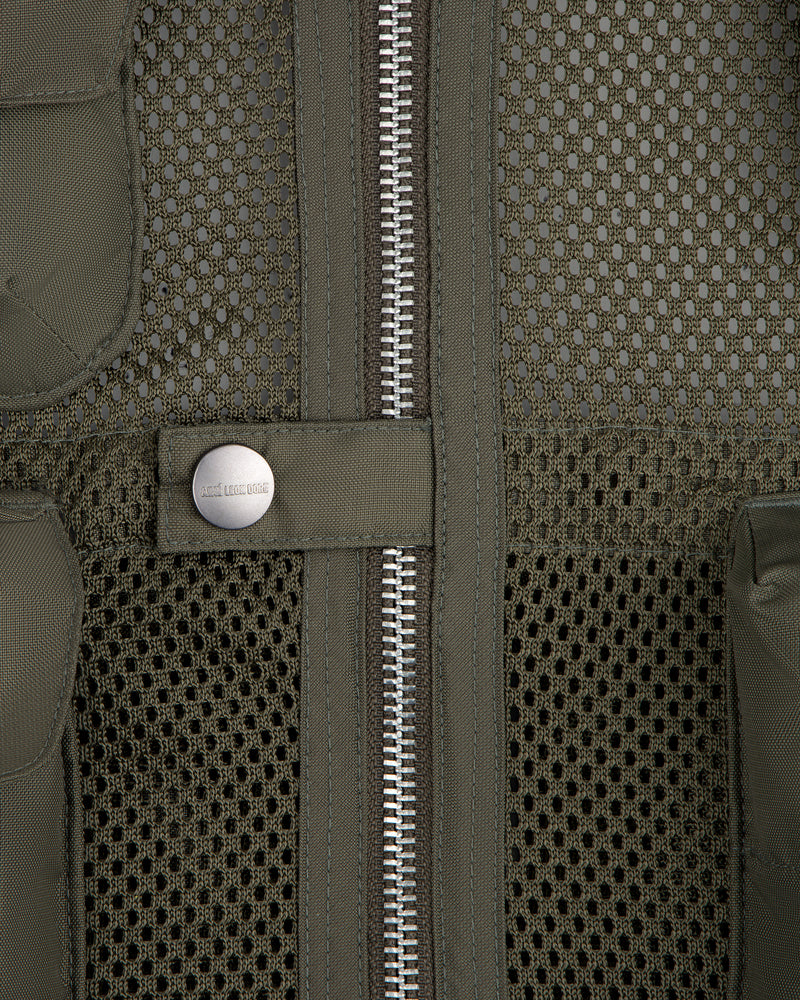 Close-up of the Nylon Utility Vest in olive green mesh, featuring a zipper and snap button pocket detail.