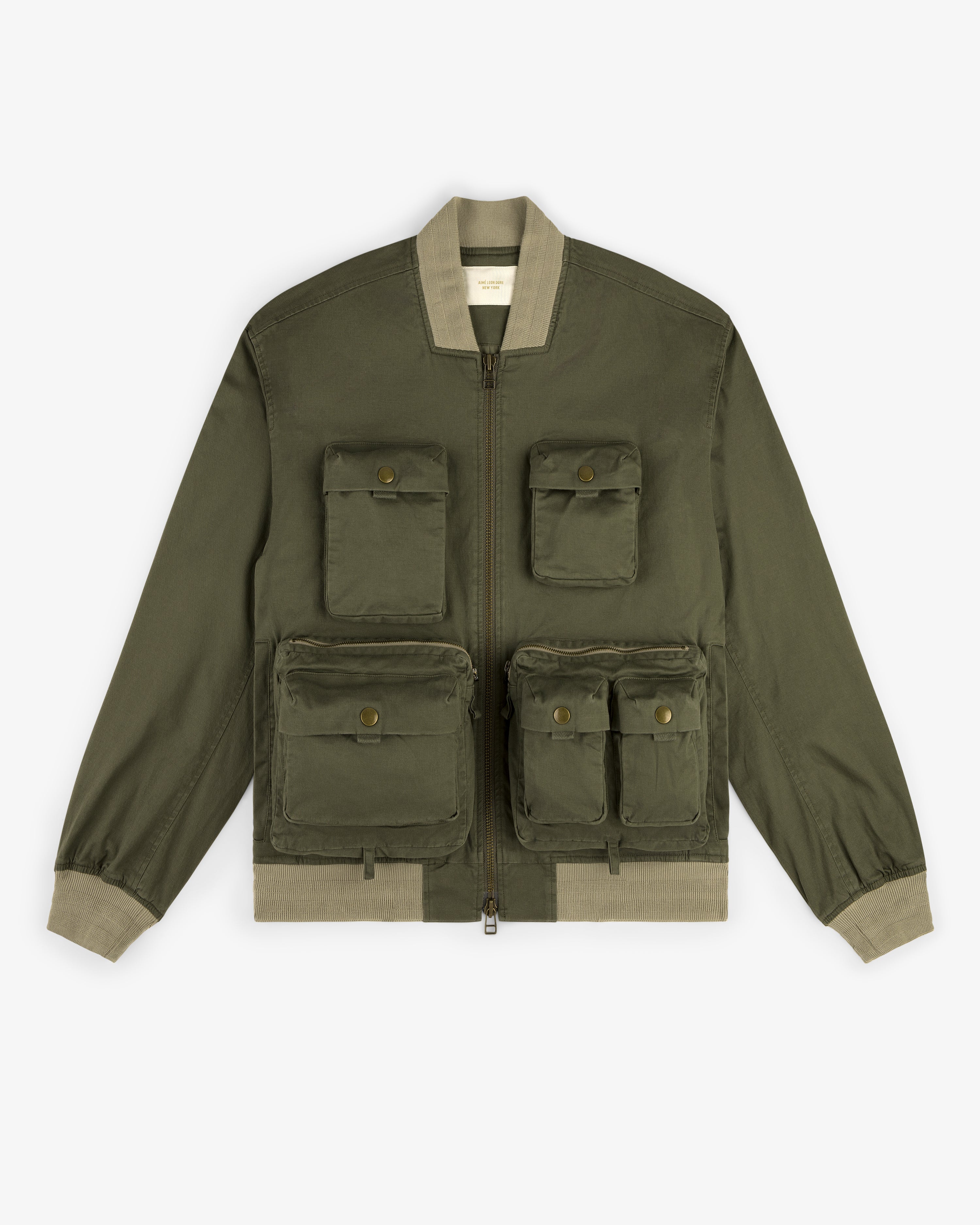Safari Utility Bomber in olive green with four front flap pockets and beige ribbed cuffs, collar, and waistband.