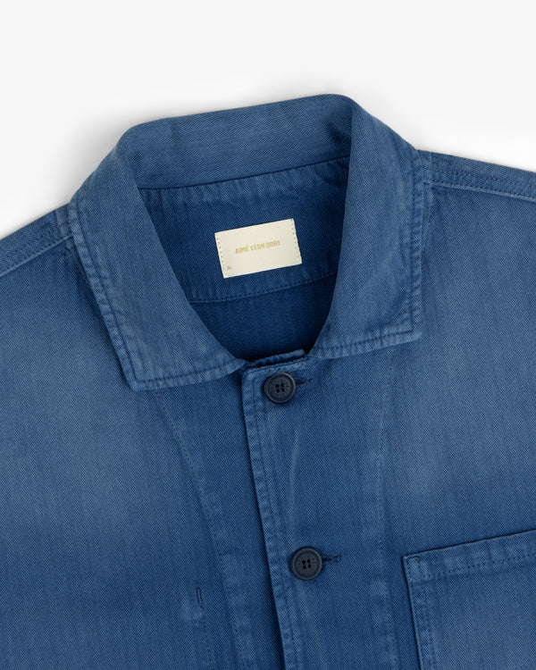 Sun Faded Chore Jacket in blue denim with collar, buttons, and chest pocket, shown from the upper front on white.