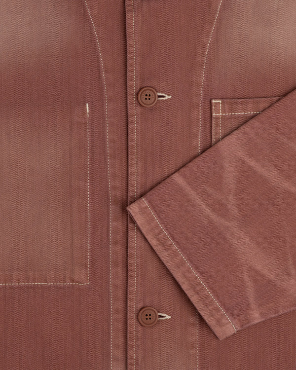 Close-up of the Sun Faded Chore Jacket featuring white stitching, a front pocket, and an angled long sleeve.
