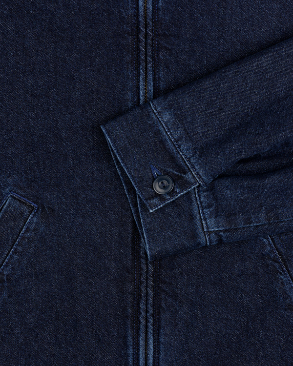 Close-up of a Denim Zip Jacket sleeve in dark blue with a buttoned cuff and visible pocket seams.