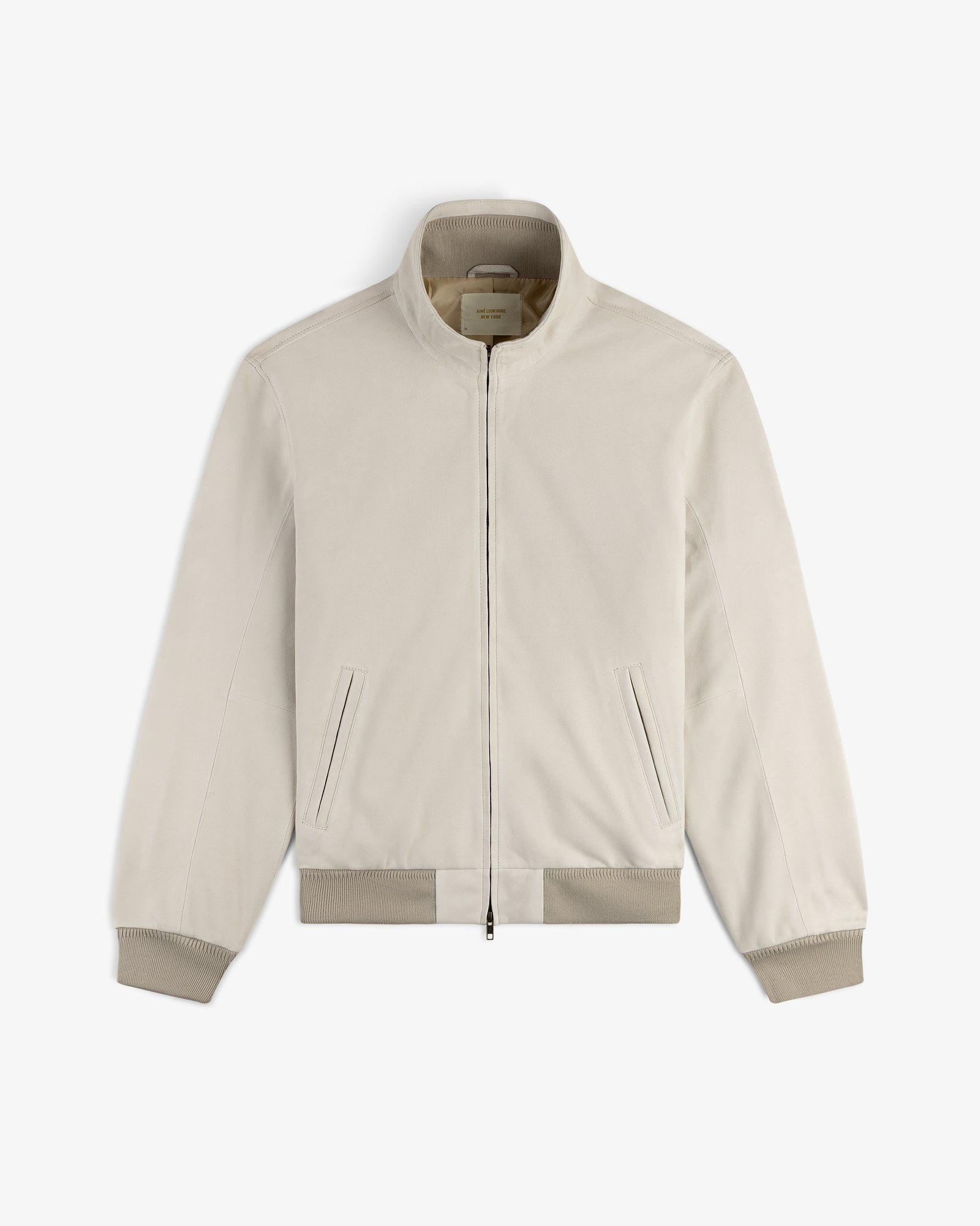 Suede Track Jacket in light beige with zip-up front, stand collar, ribbed cuffs, and side pockets, displayed flat.