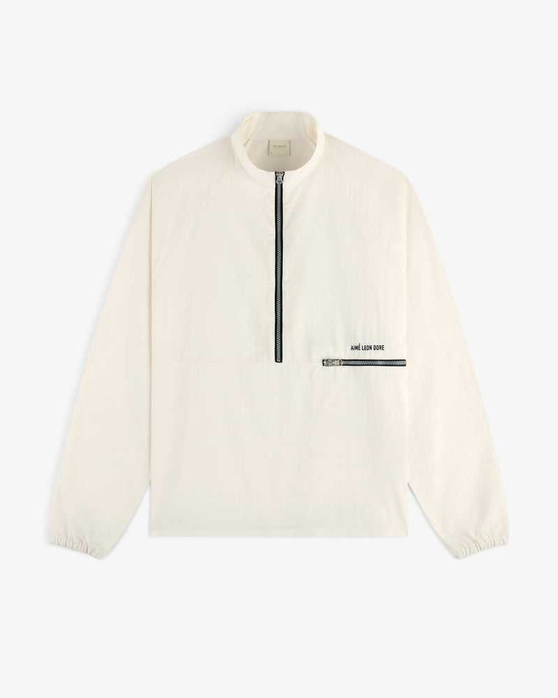 Off-white long-sleeve Nylon Packable Windbreaker with half-zip, black chest pocket, and ARE LOS DOIT print near pocket.
