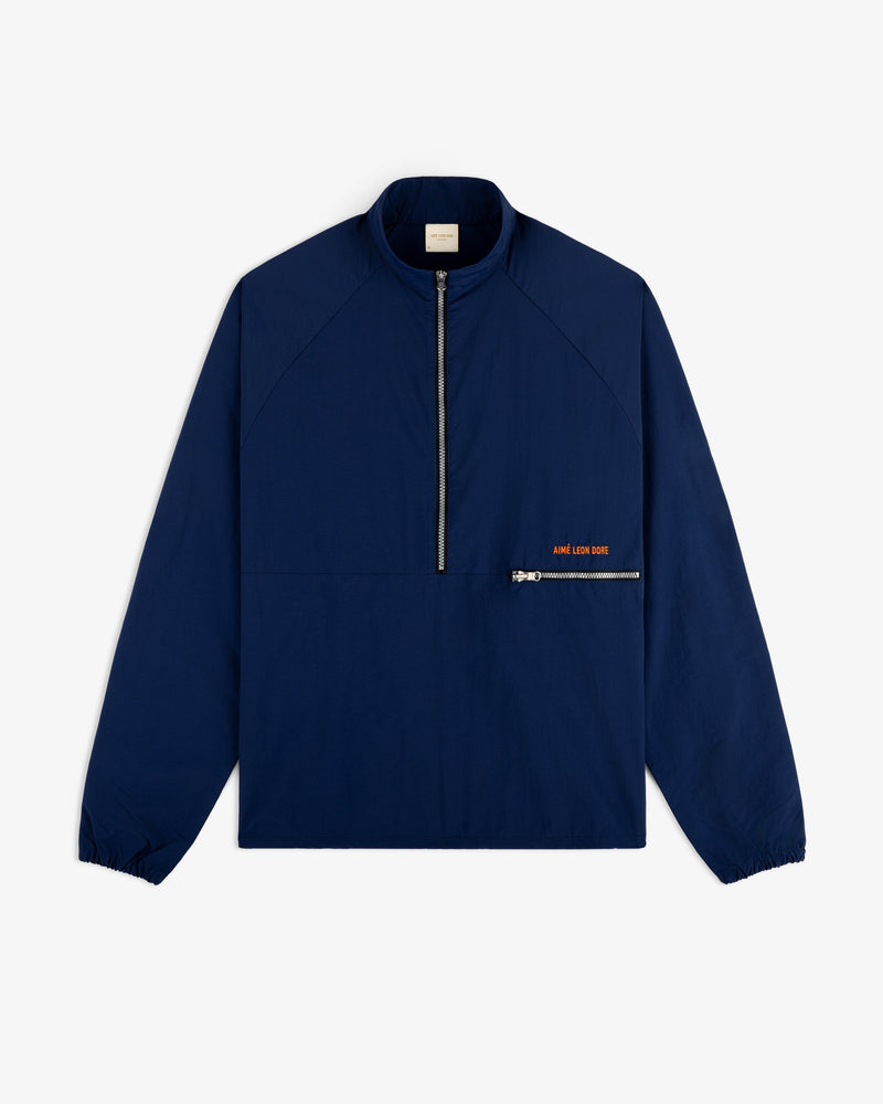 Nylon Packable Windbreaker in navy blue with half-zip front, diagonal pocket, and subtle orange text.