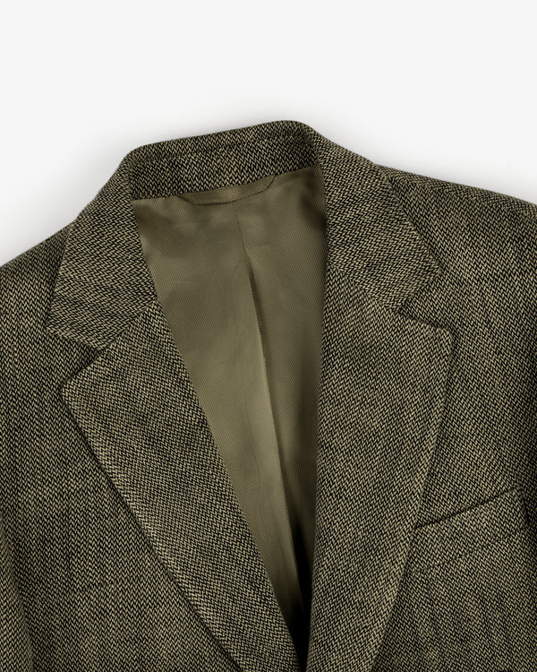 Close-up of the Single-Breasted Yarn Dyed Linen Suit Jacket featuring brown tweed and an olive green lining.